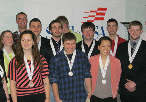 Students wearing the medals they won in the competition