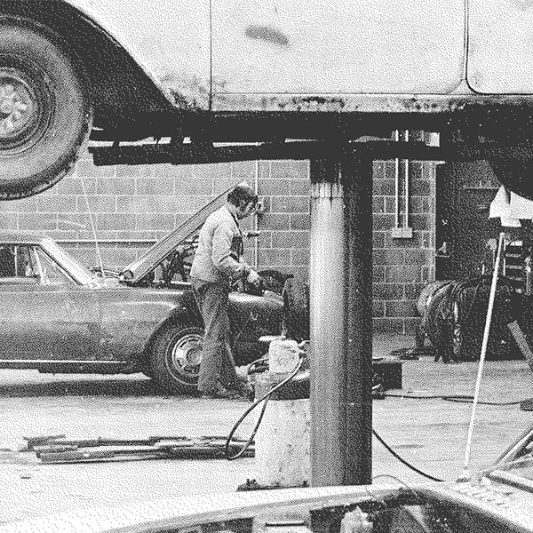 Vintage image of man working on automobile