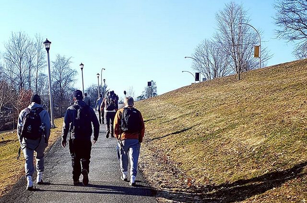 Three students standing outside on a winter day