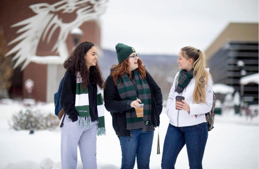 Three students standing outside on a winter day